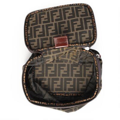 Fendi: A set comprising a clutch and a toiletry bag both of zucca
