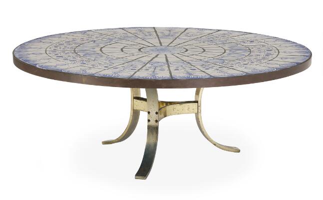 Coffee table with brass frame. Circular top with tiles in blue and light tones. Brass edge. Signed Eisen 1977. H. 48 cm. Diam. 132 cm.