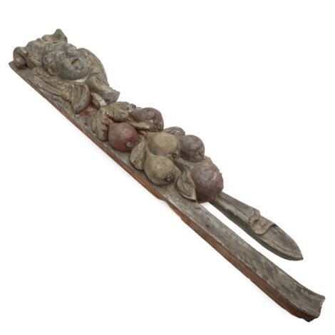 A circa 1700 Baroque painted wood carving, adorned with putto, foliage and fruit. L. 120. W. 25 cm.