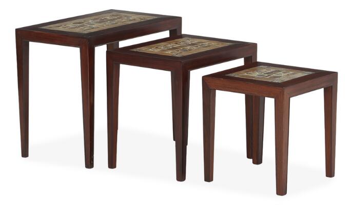 A set of three rosewood nesting tables inlaid with “Baca” faience tiles, Royal Copenhagen. Model 163. Manufactured and marked by Haslev Møbelsnedkeri. H. 50.5/44.5/39 cm. L. 59/47/35.5 cm. W. 35.5 cm. (3)