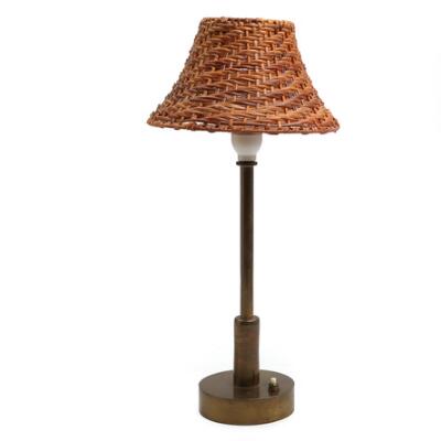 Table lamp in patinated brass with circular base and push switch, shade of rattan. 1950s. H. 48 incl. shade.