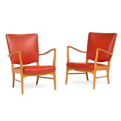 A pair of easy chairs with beech frame. Seat and backrest upholstered in red vinyl. Manufactured circa 1940–1950s. (2)