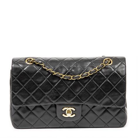 Chanel: A "Classic Double Flap" handbag in black quilted leather with double chain handle and gold-toned hardware.
