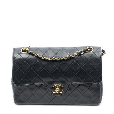 Chanel: A "Small Curved Double Flap" bag in black quilted leather with double chain strap and gold toned hardware.