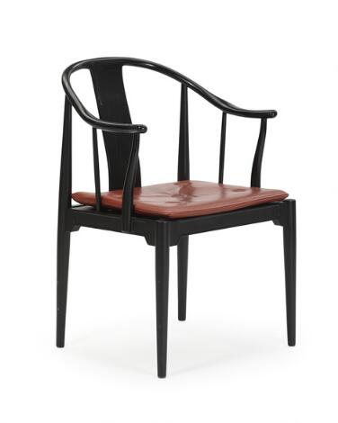 Hans J. Wegner: "China-Chair". Armchair with blacklacquered ash frame, loose cushion with brown leather. Manufactured by Fritz Hansen.