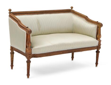 A small children's sofa in oak with striped silk upholstery. French Louis XVI style, 20th century. H. 65 cm. W. 100 cm. D. 50 cm.