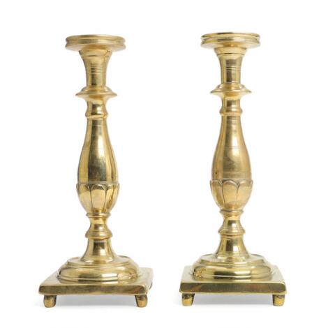 A pair of almost identical Baroque brass candlesticks with baluster-form stems. 18th century. H. 27 cm. (2)