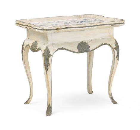 A Danish tile table of painted wood. Tiles c. late 18th century. The table 20th century. H. 72 cm. L. 81 cm. W. 55 cm.