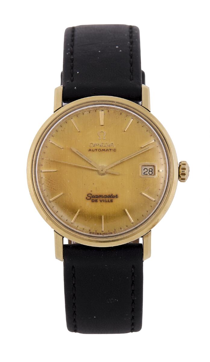 Seamaster De Ville of 14k gold and steel, ref. 166.020. Mechanical movement with automatic winding and date indication, cal. 562. Black calfskin strap with later C-clasp of gilt steel. Ø 34 mm. 1966.