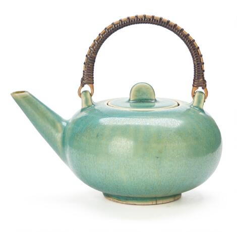 Saxbo: Small stoneware teapot decorated with turquoise-green glaze. H. incl. handle 14.5. L. 16.5.
