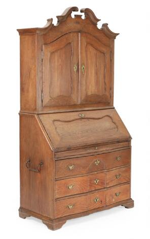 Baroque oak bureau cabinet with two doors, writing flap and three drawers. 18th century. H. 211. L. 111,5. W. 53,5. cm.