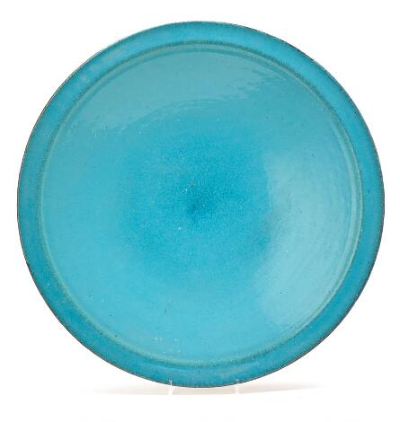 Grethe Lindblad: Large circular earthenware dish decorated with turquoise-blue glaze. Underside unglazed.