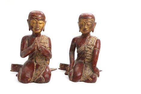 Two figures of carved and red lacquered wood in the form of seated monks. Burma. Circa 1900. H. 35 cm. (2)