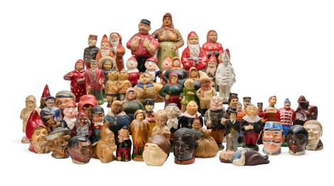 A collection of money boxes in the form of various figures, gnomes etc. Primarily glazed pottery. Denmark early 20th century. (62)