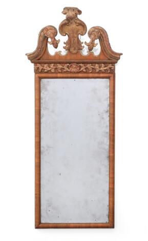 English Queen Anne mirror in walnut frame and gilded wood. Later facet-cut mirror glass. 18th century. H. 130 cm. W. 56 cm.